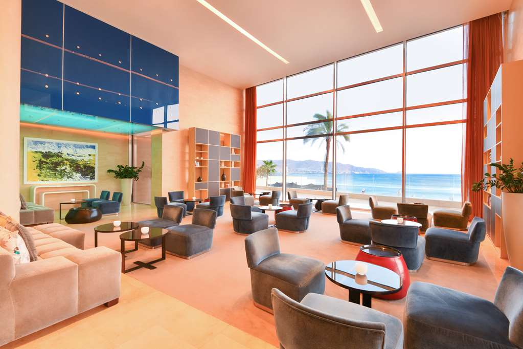 Kempinski Hotel Aqaba Aqua Lounge Indoor seating area with views of the Red Sea.